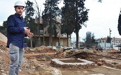 Excavation director, Alex Wiegmann, alongside an ancient winery complex uncovered on the site of the former Schneller IDF base in Jerusalem. (Israel Antiquities Authority)