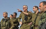 File: Brig.-Gen. Ofek Buchris, second right, motions to then-IDF chief of staff Benny Gantz during a tour in northern Israel, when Buchris was head of the IDF's Bashan Division in 2014. (IDF Spokesperson's Unit)