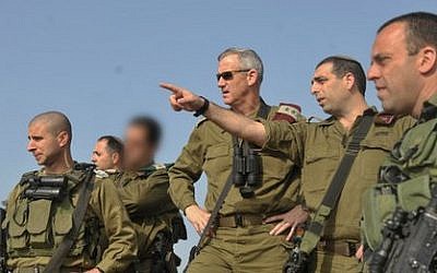 File: Brig.-Gen. Ofek Buchris, second right, motions to then-IDF chief of staff Benny Gantz during a tour in northern Israel, when Buchris was head of the IDF's Bashan Division in 2014. (IDF Spokesperson's Unit)