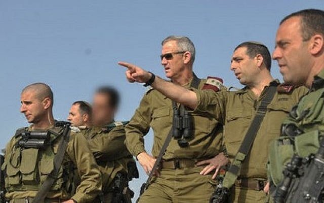 File: Brig.-Gen. Ofek Buchris, second right, motions to then-IDF chief of staff Benny Gantz during a tour in northern Israel, when Buchris was head of the IDF's Bashan Division in 2014. (IDF Spokesperson's Unit) File: Brig.-Gen. Ofek Buchris, second right, motions to then-IDF chief of staff Benny Gantz during a tour in northern Israel, when Buchris was head of the IDF's Bashan Division in 2014. (IDF Spokesperson's Unit)