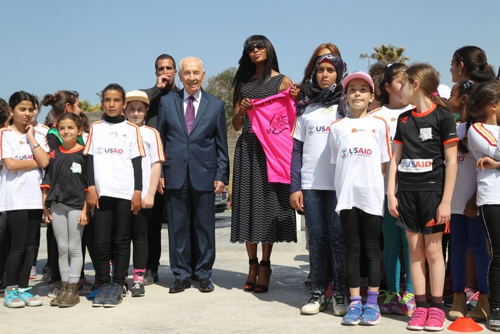 Supermodel Naomi Campbell being presented with a soccer jersey by one of the girls coexistence soccer teams sponsored by the Peres Center (Courtesy Rafi Delouya)