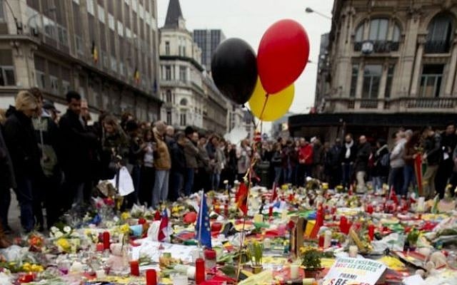 Three balloons in the colors of the Belgian flag fly as people mourn for the victims of the bombings at the Place de la Bourse in the center of Brussels, Belgium, Thursday, March 24, 2016. (AP Photo/Peter Dejong) Three balloons in the colors of the Belgian flag fly as people mourn for the victims of the bombings at the Place de la Bourse in the center of Brussels, Belgium, Thursday, March 24, 2016. (AP Photo/Peter Dejong)