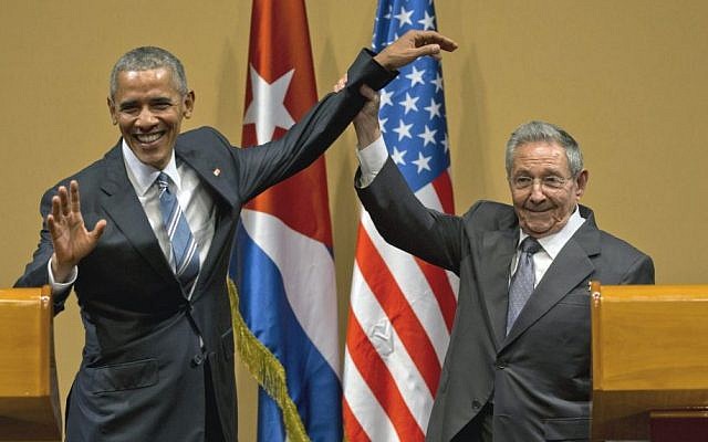 Cuban President Raul Castro, right, lifts up the arm of US President Barack Obama at the conclusion of their joint news conference at the Palace of the Revolution, Havana, Cuba, March 21, 2016. (AP/Ramon Espinosa) 