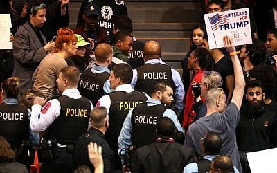 A demonstrator is removed by Chicago police during a rally for Republican presidential candidate Donald Trump at the University of Illinois at Chicago Pavilion in Chicago on Friday, March 11, 2016. Trump canceled one of his signature rallies on Friday, calling off the event in Chicago due to safety concerns after protesters packed into the arena where it was to take place. (Chris Sweda/Chicago Tribune via AP) 