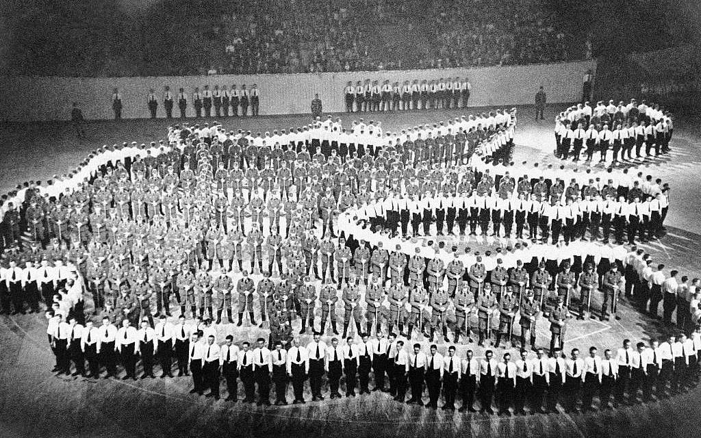An Associated Press photograph shows what it calls men 'making up this human map of greater Germany. They are members of Labor Service Corps at the International Handicraft Congress in Berlin, May 28, 1938. Those in white shirts represent the boundaries; those inside, in brown shirts, with spades, are intended to represent Germany's network of auto roads. Note that the absorption of Austria is recognized. Note also the little island at the upper right representing East Prussia, and the deep dent at the right center where Czechoslovakia sticks its long neck into Germany.' (AP Photo)