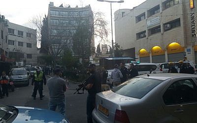 Police take up positions at the scene of a shooting attack on Salah a-Din street in Jerusalem on March 8, 2016. (United Hatzalah)