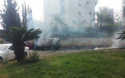 A white Hummer burns after an explosion went off inside it in northeastern Tel Aviv on March 13, 2016. (Israel Police)