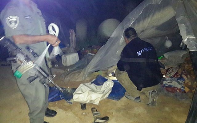 Police officers collect evidence and dismantle the makeshift living quarters being used by a group of 22 Palestinians who were living in Israel illegally, near the Besor Stream national park on March 10, 2016. (Israel Police)