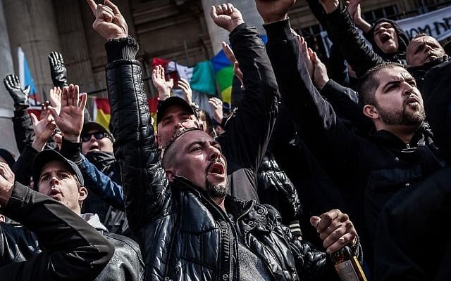 Far-right demonstrators protest at a memorial site at the Place de la Bourse in Brussels, Sunday, March 27, 2016. (AP Photo/Valentin Bianchi) Far-right demonstrators protest at a memorial site at the Place de la Bourse in Brussels, Sunday, March 27, 2016. (AP Photo/Valentin Bianchi)
