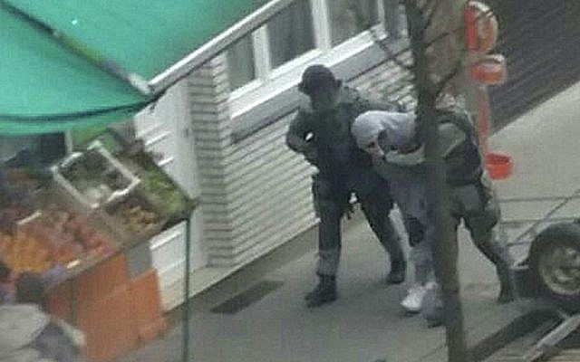 In this Friday, March 18, 2016 photo made available Monday, March 21, an unidentified man believed to be connected to key suspect in the November 2015 Paris attacks Salah Abdeslam is detained by police during a raid in the Molenbeek neighborhood of Brussels, Belgium. (AP Photo/Zouheir Ambar) In this Friday, March 18, 2016 photo made available Monday, March 21, an unidentified man believed to be connected to key suspect in the November 2015 Paris attacks Salah Abdeslam is detained by police during a raid in the Molenbeek neighborhood of Brussels, Belgium. (AP Photo/Zouheir Ambar)