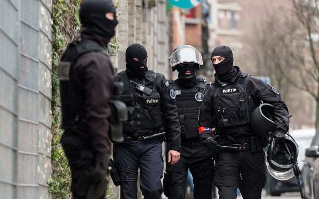 Police officers stand guard during a raid in the Molenbeek neighborhood of Brussels, Belgium, on March 18, 2016. (AP/Geert Vanden Wijngaert) Police officers stand guard during a raid in the Molenbeek neighborhood of Brussels, Belgium, on March 18, 2016. (AP/Geert Vanden Wijngaert)