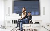 Gilbert Chikli, 50, and his wife, Shirly Chikli, 31, pose at their home in Ashdod on March 28, 2016. (AP/Oded Balilty)