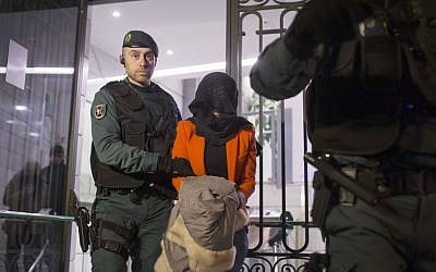 Illustrative photo of a Spanish Civil Guard policeman detaining a suspect in Madrid, Spain. February 17, 2016 (AP Photo/Francisco Seco, File)