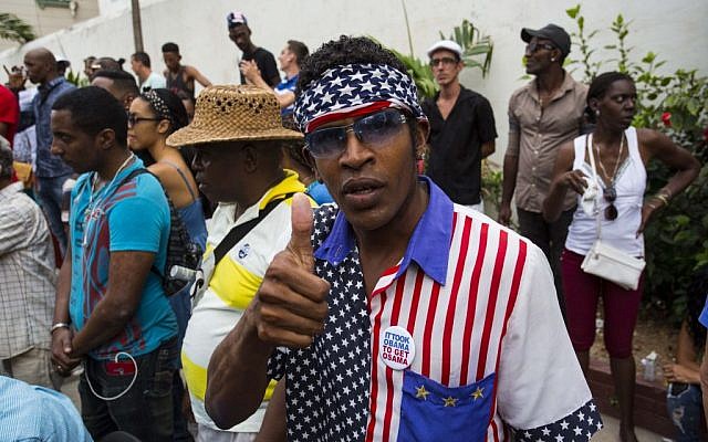 A man wearing a shirt and head scarf with a Stars and Stripes motif flashes a thumbs up at a weekly rumba dance gathering in Havana, Cuba, Saturday, March 19, 2016. (AP Photo/Desmond Boylan) A man wearing a shirt and head scarf with a Stars and Stripes motif flashes a thumbs up at a weekly rumba dance gathering in Havana, Cuba, Saturday, March 19, 2016. (AP Photo/Desmond Boylan)