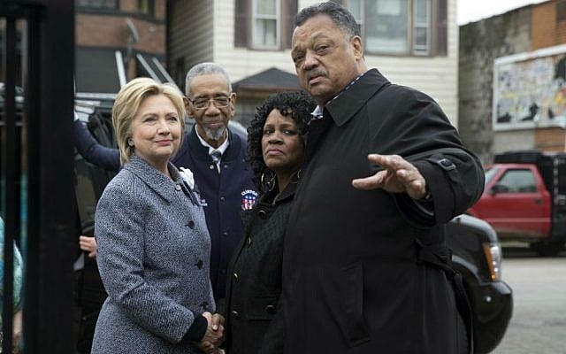 Democratic presidential candidate Hillary Clinton is greeted by Rev. Jesse Jackson, right, Diane Latiker of Kids off the Block memorial, second from right, and Rep Bobby Rush, D-Illinois, as she arrives to visit Kids off the Block memorial l to children killed by gun violence in Chicago, Monday, March 14, 2016. (AP Photo/Carolyn Kaster)