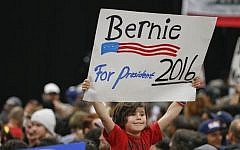 A child holds a sign supporting Democratic presidential candidate Sen. Bernie Sanders while awaiting his arrival at the San Diego Convention Center Tuesday, March 22, 2016. (AP/Lenny Ignelzi)