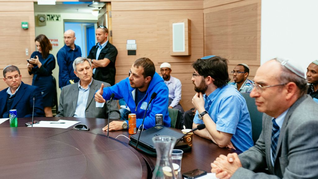 FSU immigrant David (in blue sweatshirt) gives testimony at the Knesset's Aliya Committee on March 8, 2016. Also pictured, from left: Giyur KaHalacha's Rabbi Seth Farber, Eli Cohen, director, and lawyer Elad Caplan. (Michael Shapochnic, Giyur KaHalacha) FSU immigrant David (in blue sweatshirt) gives testimony at the Knesset's Aliya Committee on March 8, 2016. Also pictured, from left: Giyur KaHalacha's Rabbi Seth Farber, Eli Cohen, director, and lawyer Elad Caplan. (Michael Shapochnic, Giyur KaHalacha)