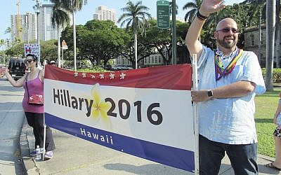 In this Thursday, March 24, 2016 photo, Michael Golojuch Jr., right, who leads the Lesbian, Gay, Bisexual and Transgender Caucus of the Democratic Party of Hawaii, and his sister, Michele Golojuch, a teacher, left, show their support for presidential candidate Hilary Clinton in Honolulu.(AP Photo/Cathy Bussewitz) 