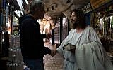 A man dressed as Jesus Christ greets a storeowner in the Old City of Jerusalem on May 13 2013. (Sarah Schuman/ Flash90)