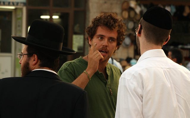 A secular Jew talks to an ultra-Orthodox man about the Green Line in front of City Hall in Jerusalem, June 5, 2013. (Lucie March/Flash 90) A secular Jew talks to an ultra-Orthodox man about the Green Line in front of City Hall in Jerusalem, June 5, 2013. (Lucie March/Flash 90)