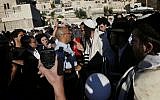 Orthodox Jewish men blow whistles as they try to disturb the monthly prayer service of the Women of the Wall at the Western Wall, August 7, 2013. (Miriam Alster/Flash90)