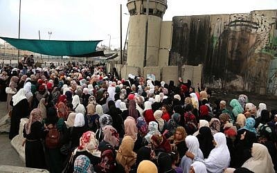 Palestinian women try to cross through the Qalandiya checkpoint on their way for Friday prayers in Al-Aqsa Mosque, June 26, 2015. (Photo by Flash90)