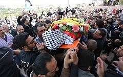 Palestinian mourners chant slogans while carrying the body of Mahmoud Shalan, 17, during his funeral in the West Bank village of Deir Debwan, near Ramallah, March 2, 2016. (Photo by Flash90)