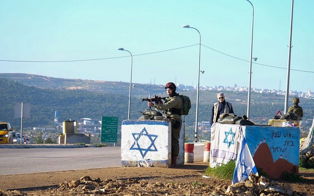 Israeli security forces guard near the scene of a driving terror attack near Gush Etzion Junction in the West Bank on March 4, 2016. (Gershon Elinson/Flash90)