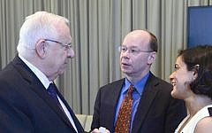 President Reuven Rivlin receives a Pew Research Center report on the 'Israeli Mosaic: Identity, Society, and Religion,' on March 8, 2016, in Jerusalem (Mark Neyman/GPO)