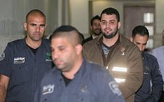 Bilal Abu Ghanem is escorted by Israeli prison officers at the Jerusalem District Court on Sunday, March 13, 2016 (Yonatan Sindel/Flash90)