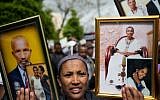 Israelis who immigrated from Ethiopia hold up family photos of loved ones who remain in Ethiopia, during a protest to bring the rest of the Falashmura to Israel, in Jerusalem, on March 20, 2016. (Yonatan Sindel/Flash90)