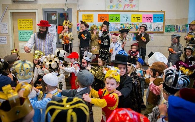 School children celebrate Purim in the ultra-Orthodox neighborhood of Mea Shearim in Jerusalem on March 22, 2016. (Yonatan Sindel/Flash90) School children celebrate Purim in the ultra-Orthodox neighborhood of Mea Shearim in Jerusalem on March 22, 2016. (Yonatan Sindel/Flash90)