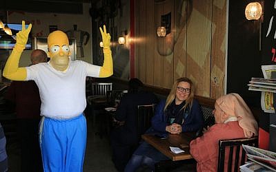 An Israeli dresses up as Homer Simpson for Purim at Jerusalem's Mahane Yehuda market on March 23, 2016. (Photo by Nati Shohat/Flash90)