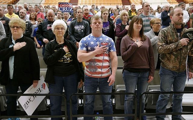 Wichita, Kansas residents prepare for the pledge of allegiance at a caucus site, Saturday, March 5, 2016, in Wichita. (AP Photo/Charles Rex Arbogast)