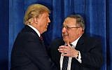 In this March 3, 2016, photo, Republican presidential candidate Donald Trump is welcomed to the stage by Maine Gov. Paul LePage at campaign stop in Portland, Maine. (AP Photo/Robert F. Bukaty)