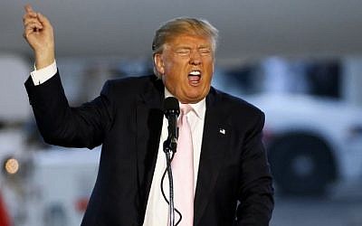 Republican presidential candidate, Donald Trump holds a plane-side rally in a hanger at Youngstown-Warren Regional Airport in Vienna, Ohio, Monday, March 14, 2016. (AP Photo/Gene J. Puskar)