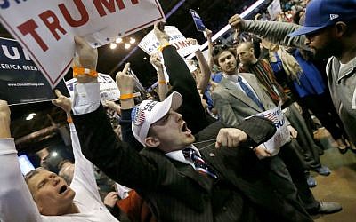 Supporters of Republican presidential candidate Donald Trump, left, face off with protesters after a rally on the campus of the University of Illinois-Chicago was canceled due to security concerns Friday, March 11, 2016. (AP Photo/Charles Rex Arbogast)