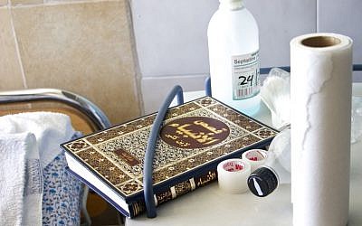 A copy of the "Story of the Prophets" near the bedside of a Syrian patient in Ziv Medical Center. March 10, 2016. (Dov Lieber / Times of Israel)