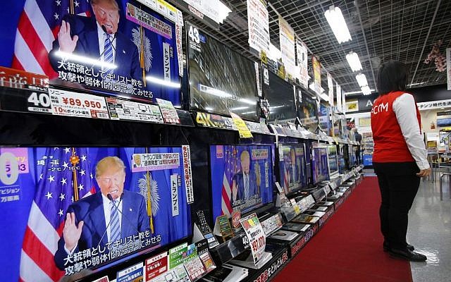 A salesclerk stands in front of flat-panel TVs showing Republican's front-runner candidate Donald Trump in a news program on the US presidential election at an electronics store in Tokyo, March 2, 2016. (AP/Shizuo Kambayashi) A salesclerk stands in front of flat-panel TVs showing Republican's front-runner candidate Donald Trump in a news program on the US presidential election at an electronics store in Tokyo, March 2, 2016. (AP/Shizuo Kambayashi)
