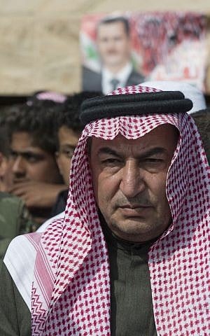 In this photo taken on Wednesday, March 2, 2016, Sheikh Ahmad Mubarak speaks to the media after signing a cease-fire declaration in Maarzaf, about 15 kilometers west of Hama, Syria. Associated Press spent five days traveling through the port of Latakia and the surrounding areas in Syria during the cease-fire. (AP Photo/Pavel Golovkin) 