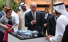 Joe Biden points to one of the Masdar City employees as Sultan Ahmed Al Jaber UAE minister of state and the chairman of Masdar City, third left, looks on during his first day tour in Abu Dhabi, United Arab Emirates, Monday, March 7, 2016. (AP/Kamran Jebreili)