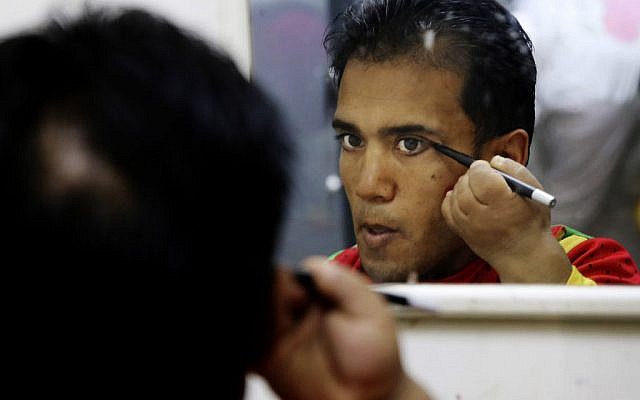 Palestinian medical clown Alaa Miqdad, prepares himself before performing for children at Al-Rantisi hospital in Gaza City, March 17, 2016. (AP/Adel Hana)