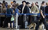 An Israeli airport security guard patrols with a dog in Ben Gurion airport near Tel Aviv, Israel, Tuesday, March 22, 2016. (AP Photo/Ariel Schalit)