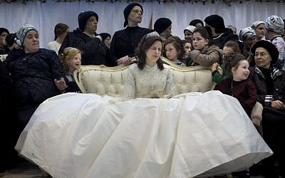 A Jewish bride sits with family members in the women's section during her wedding to the grandson of the Rabbi of the Tzanz Hasidic dynasty community, in Netanya, Israel, Tuesday, March 15, 2016. (AP Photo/Oded Balilty)