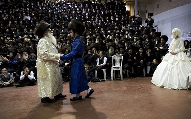 An ultra-Orthodox Jewish bride enters to the men's section of the wedding, to fulfill the Mitzvah tantz, in which family members and honored rabbis are invited to dance in front of the bride, often holding a gartel, and then dancing with the groom, during her wedding to the grandson of the Rabbi of the Tzanz Hasidic dynasty community, in Netanya, Israel, Wednesday, March 16, 2016. (AP Photo/Oded Balilty)
