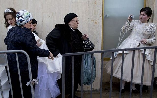 A Jewish bride arrives with family members during her wedding to the grandson of the Rabbi of the Tzanz Hasidic dynasty community, in Netanya, Israel, Tuesday, March 15, 2016. (AP Photo/Oded Balilty)
