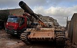 A man loyal to the Libyan armed forces sits in a tank during clashes with Islamic State group militants west of Benghazi, Libya, on Monday, March 7, 2016. (AP/Mohammed el-Shaiky, File)