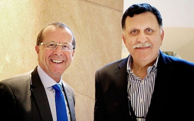 In this Feb. 17, 2016 file photo, UN special envoy for Libya Martin Kobler, left, is greeted by Fayez Serraj, Libyan designated-prime minister and head of the presidential council, in Cairo, Egypt. (AP Photo/Maggie Michael, File)