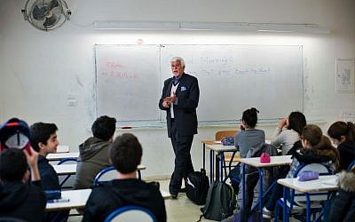 In this picture taken Thursday, Feb. 25, 2016, Thomas Webber gives an English lesson to students at the Lycée Français Charles de Gaulle school in Damascus, Syria. (AP Photo/Hassan Ammar)