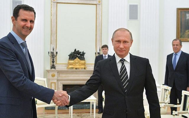 File: Russian President Vladimir Putin, center, shakes hand with Syrian President Bashar Assad as Russian Foreign Minister Sergey Lavrov, right, looks on in the Kremlin in Moscow, Russia, Tuesday, October 20, 2015. (Alexei Druzhinin, Sputnik, Kremlin Pool Photo via AP, File)